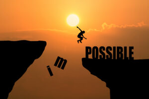 man jumping impossible possible cliff sunset background business concept idea