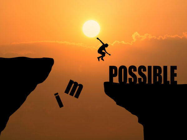 man jumping impossible possible cliff sunset background business concept idea